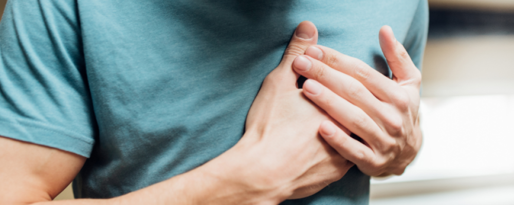 person clutching chest from pain